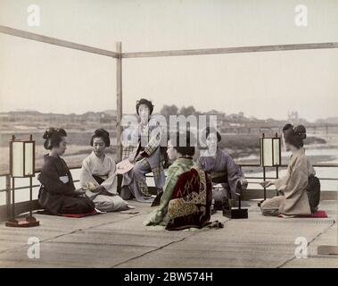 Vintage 19th century photograph - group of Japanese geishas on a tea house balcony, Kyoto Stock Photo