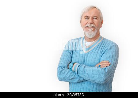 Freestyle. Senior bearded man in sweater standing isolated on white crossed arms smiling happy Stock Photo