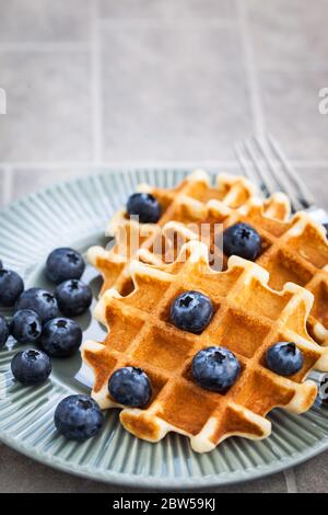 Homemade belgian waffles with fresh blueberries, close up Stock Photo