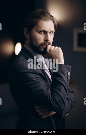 Portrait of handsome man in formal wear standing at office Stock Photo