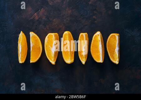 Seven Orange slices on a dark background.  Stock Photo