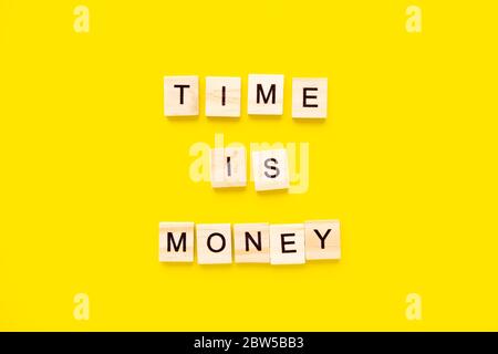 Words Time is money on yellow background. business concept Stock Photo