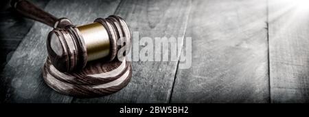 Gavel And Block On Wooden Desk With Sunlight - Law And Justice / Auction Concept