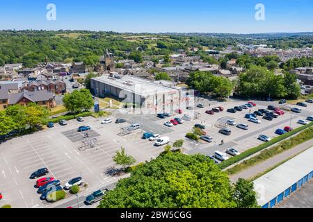 Aerial photo of people in the UK queuing following social distancing rules due to coronavirus at a Tesco supermarket in the village of Cleckheaton, We Stock Photo