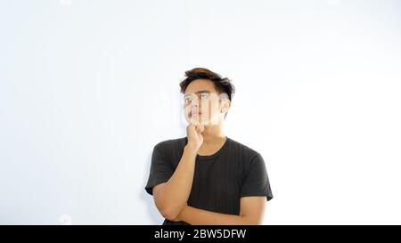 portrait of young asian Man thinking isolated on white background Stock Photo