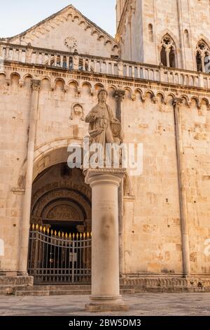 Statue of St Lawrence with St Lawrence cathedral in Trogir, Croatia. Stock Photo