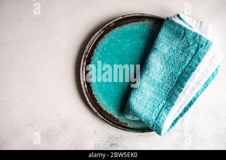 Table setting with modern ceramic dishware and cutlery on grey concrete background with copy space Stock Photo