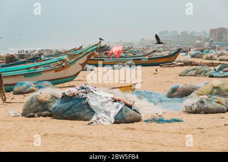 Hundreds of fishing boats and nets parked on the shore of Marina Beach in Chennai, India Stock Photo