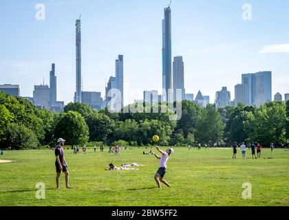 New York, USA,  29 May 2020.  People enjoy the warm weather while mostly keeping social distancing in Central Park's Great Lawn during the coronavirus