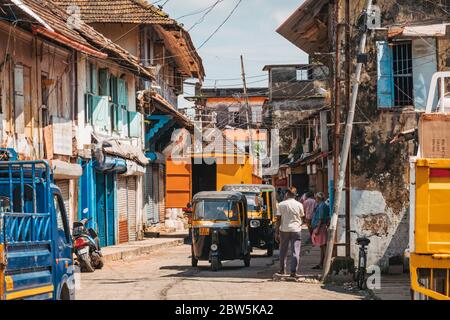 Auto rickshaws ride between old colonial Portuguese-era buildings in Mattancherry, Kochi, India Stock Photo