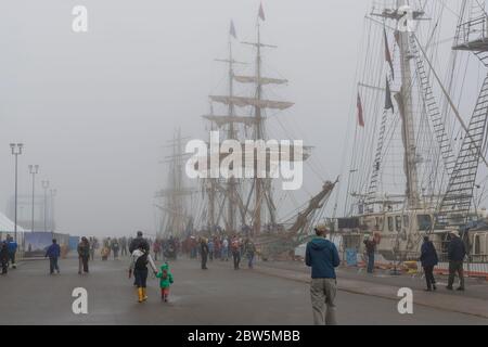 Saint John, New Brunswick, Canada - August 20, 2017: Tall ships at the annual Festival Of Sail on a slightly foggy day in Saint John. Stock Photo