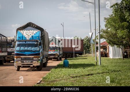 Elegu, Uganda. 28th May, 2020. A truck driver prays beside his vehicle, at the border between Uganda and South Sudan as he waits for his results of a coronavirus test.Uganda closed its borders in March to everyone except cargo planes and truck drivers. Credit: SOPA Images Limited/Alamy Live News Stock Photo