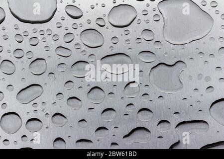Abstract art texture background of raindrops on a brushed steel surface Stock Photo
