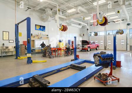 Automotive mechanic students listening to teacher in high school career technical education class. Stock Photo
