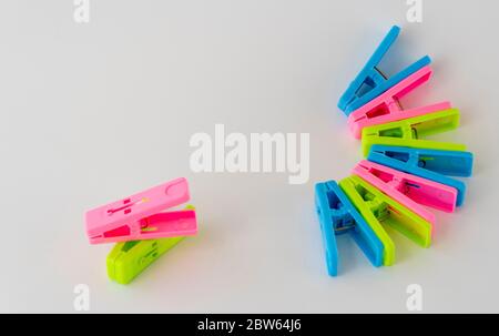 The multi-colored clothespins on a white background. Stock Photo