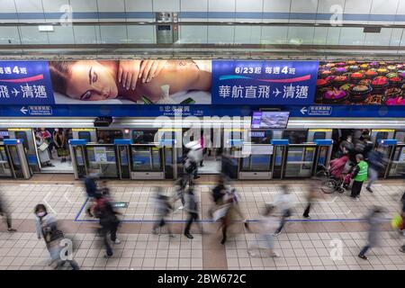 Commuters wearing face masks as protection against the covid-19 virus at a Taipei MRT / subway station, Taipei, Taiwan, February 21, 2020 Stock Photo