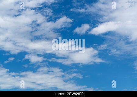 Beautiful blue sky with white cloud. Fluffy clouds moving in the wind on the blue sky. Stock Photo