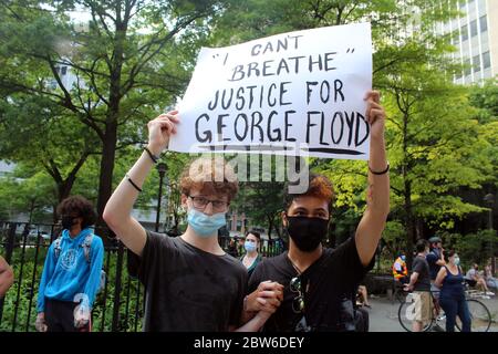 May 29, 2020, New York, New York, USA: Large crowds have taken to the streets in New York City to protest the death of George Floyd and instances of police brutality for the second day in a row. Hundreds, masked face, had gathered without applying social distancing in Foley Square in front of the Court of Justice in Manhattan, shouting their anger and calling on the City Council to reintroduce and pass a chokehold bill. These 2 young men demonstrate by holding hands. Protests in Brooklyn turned violent by night, with a dozen NYPD officers injured and at least 120 arrests. (Credit Image: © Mari Stock Photo