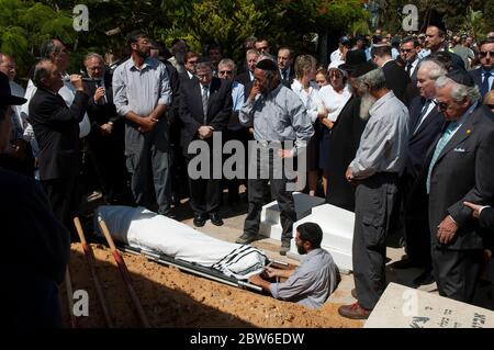 Orthodox Jewish pallbearers lower the shroud-covered body of renowned Holocaust survivor and Nazi-hunter Simon Wiesenthal into a grave at his funeral in the town of Herzliya in Israel. Holocaust survivor Wiesenthal dedicated his life to raising public awareness of the need to hunt and prosecute Nazis who had evaded justice. Stock Photo