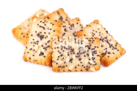 Square poppy seeds and sesame crackers isolated on white background. Dry cracker cookies isolated. Salty snacks isolated. Stock Photo