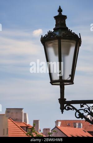 Detail of an old-fashioned street lantern in Prague and the sky in the background Stock Photo