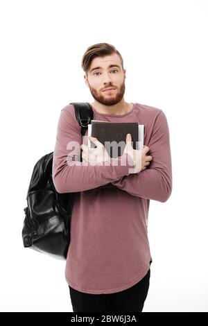 Unhappy male student with a backpack and books on the floor isolated on ...