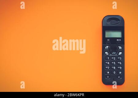 Wireless cordless telephone, radiotelephone, dect cordless phone wireless phone, radiotelephone, radio phone on orange background Stock Photo