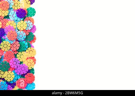 Multi-colored designer background. Multi-colored details in the form of snowflakes from the children's designer. Plastic discs for the development Stock Photo