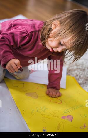 Download Little boy and girl drawing with crayons Stock Photo - Alamy