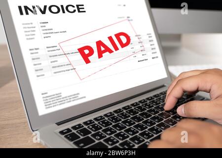 Businessman work Using The Computer Calculating  Invoice In Office Invoice Form and Accountant Checking Invoice Stock Photo