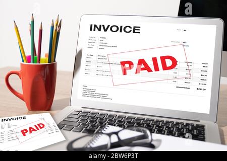 Businessman work Using The Computer Calculating  Invoice In Office Invoice Form and Accountant Checking Invoice Stock Photo
