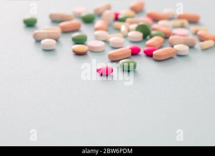 Medicine pills on blue pastel background. Colorful variation of pharmacy products, closeup view. Medical treatment, health concept Stock Photo