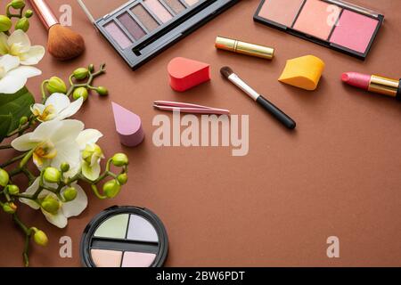 Makeup natural cosmetic products against brown color background. Make up female accessories, flat lay, top view, copy space Stock Photo