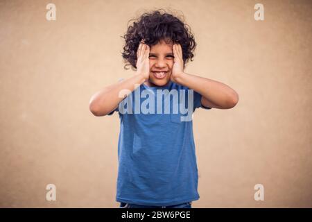 Kid boy feels strong head ache. Children, healthcare and medicine concept Stock Photo