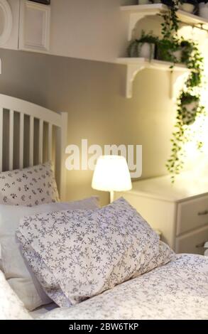 Set of various pillows with different natural ornaments and colors arranged on bed in modern apartment Stock Photo