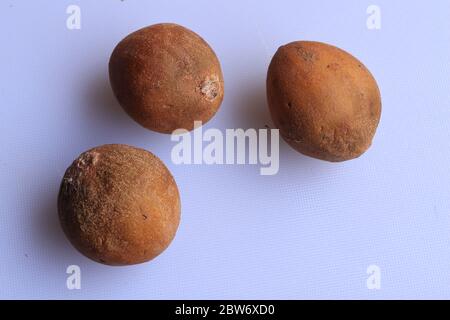 Ripe fresh sapota fruits isolated on white background Stock Photo