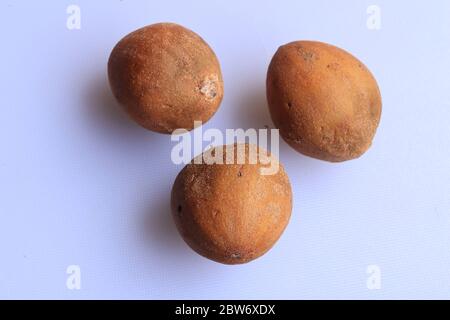 Ripe fresh sapota fruits isolated on white background Stock Photo