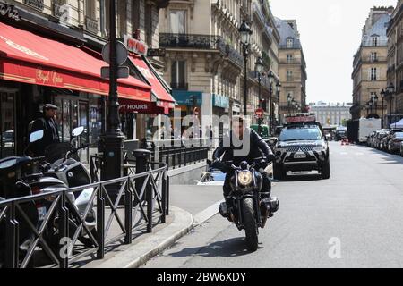 Tom Cruise riding motorbike in front of crowd filming Mission Impossible 3 in Paris, France, 2017 Stock Photo