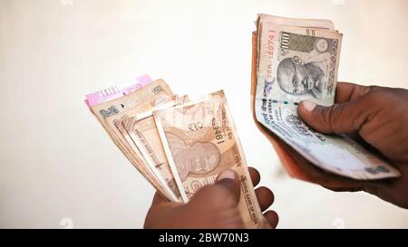 Man recounts indian rupee money. Stock Photo