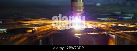 Plasma cutting machine cuts metal material with sparks Stock Photo