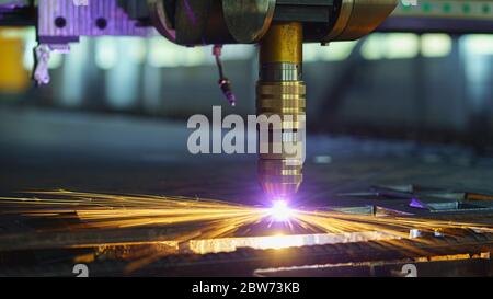 Laser metal cut machine with sparks flying around Stock Photo