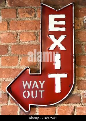 Close up of Vintage red sign Exit/Way Out, retro style on the brick wall of the building Stock Photo