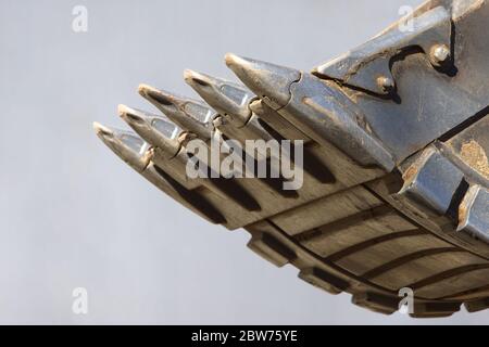 Close up of excavator(grader, tractor) bucket, soft focus, isolated on grey background Stock Photo