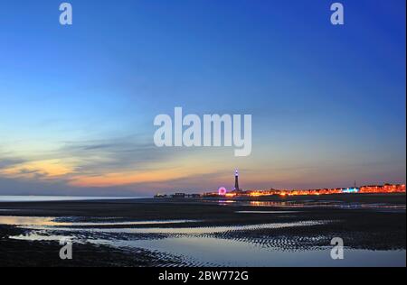 Blackpool Tower, the Ferris wheel and an empty beach at dusk in summer Stock Photo