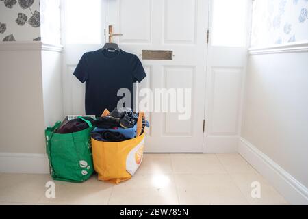 A bag of clothes and items waiting to be donated to a charity or thrift shop. Stock Photo