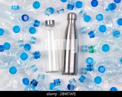 Reusable glass and metal bottles among plenty of plastic bottles Stock Photo