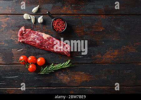 Organic machete steak or hanging tende cut, with rosemary over wood background Top view space for text. Stock Photo