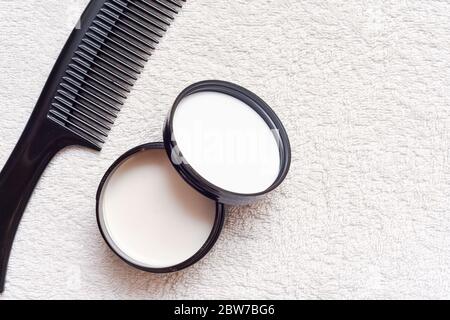 Men's hair product paste with black comb isolated on white background Stock Photo