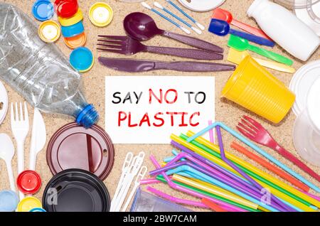 Disposable single use plastic bottles, cups, forks, spoons and drinking straws that cause pollution of the environment Stock Photo
