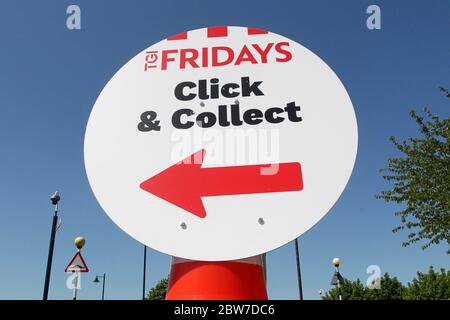 Signs give instructions for Click & Collect customers at TGI Fridays restaurant in the Braintree Village shopping outlet during the COVID-19 pandemic Stock Photo